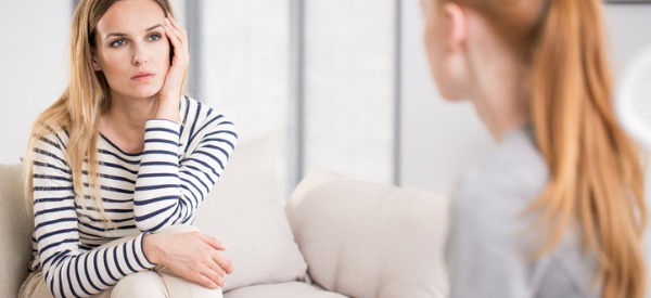 A mental health counselor listening to a client.