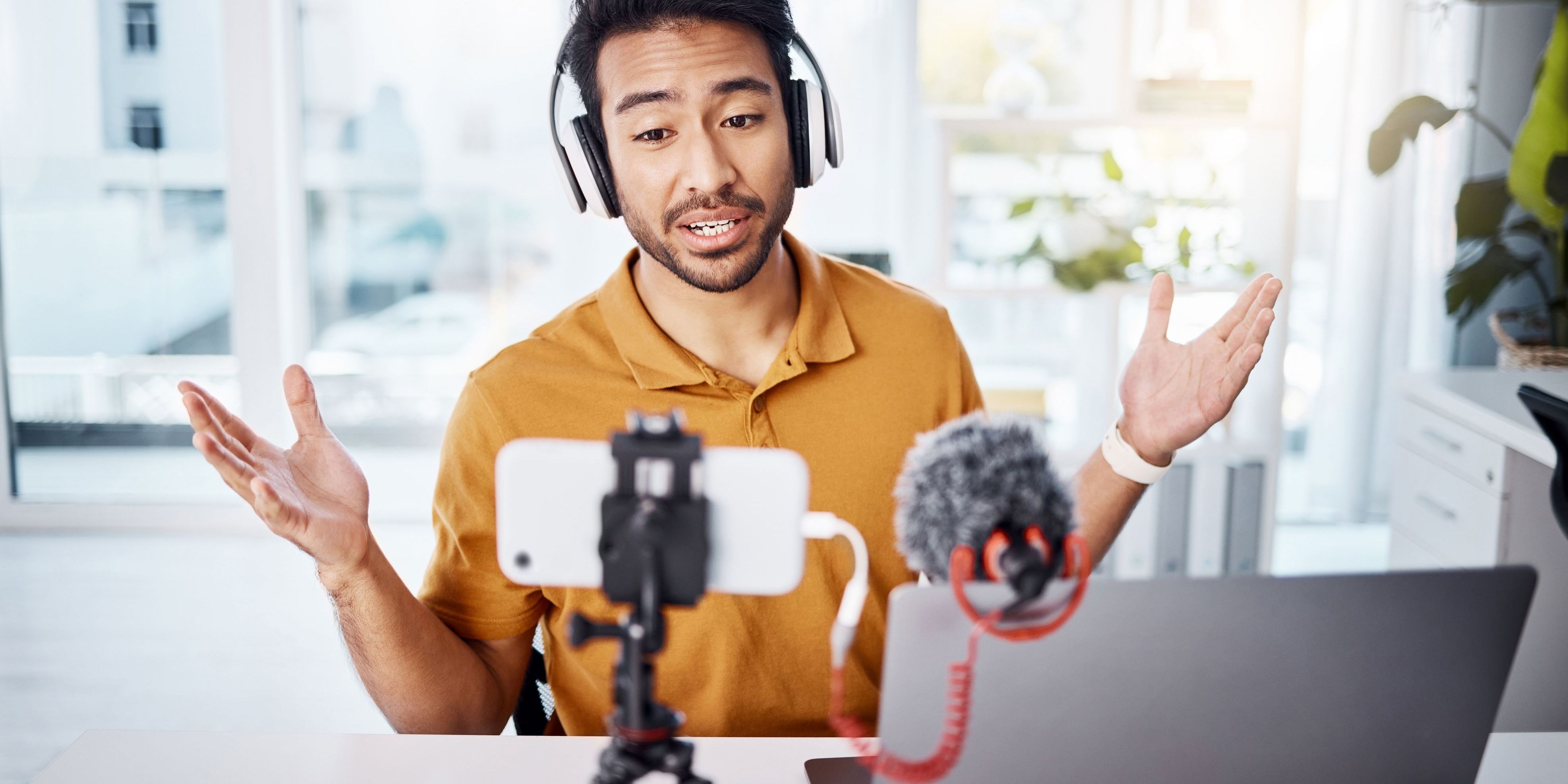 A digital content creator recording a broadcast in his home office.