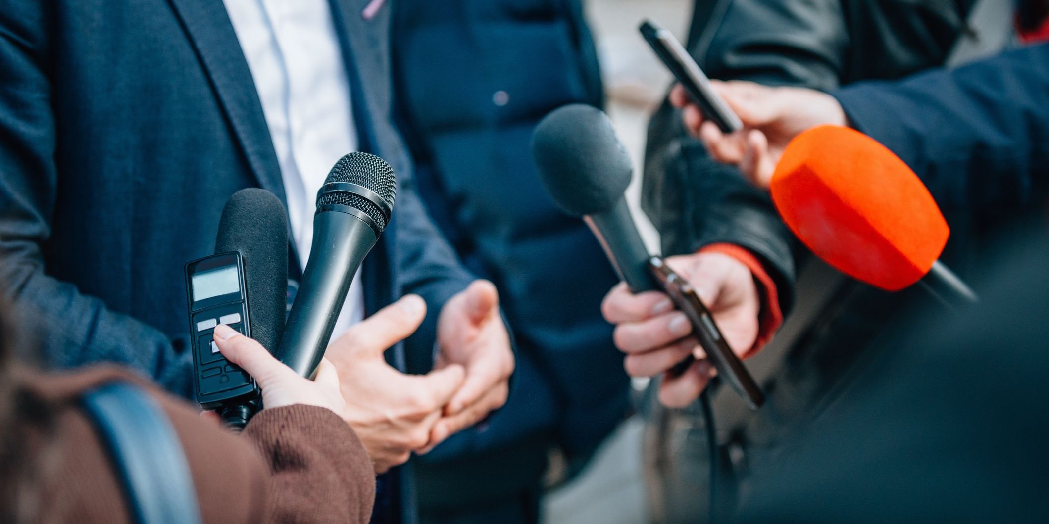 A political reporter conducting an interview at a political event.