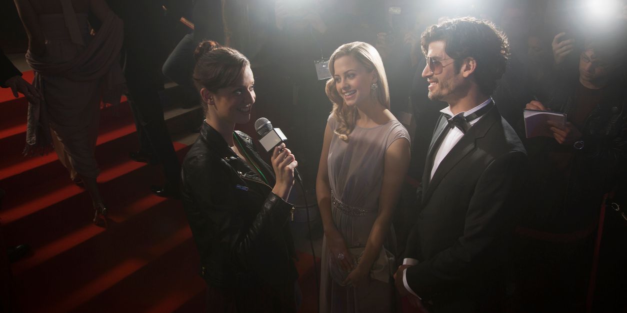 An entertainment journalist interviewing a celebrity couple.