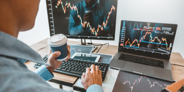 A hedge fund manager looking at stock market action on his computer.