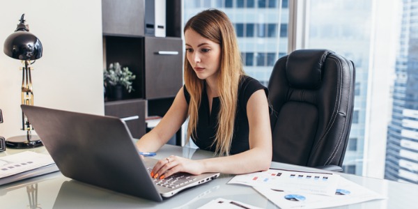 An actuary sitting at her computer.