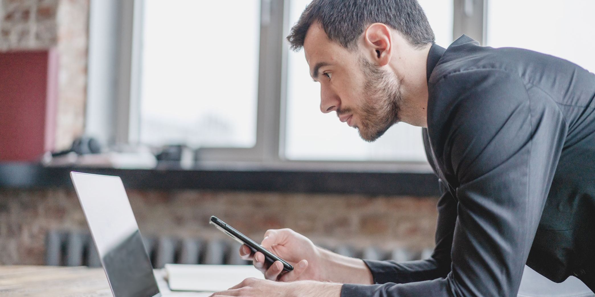An investigative reporter looks intently at his computer.