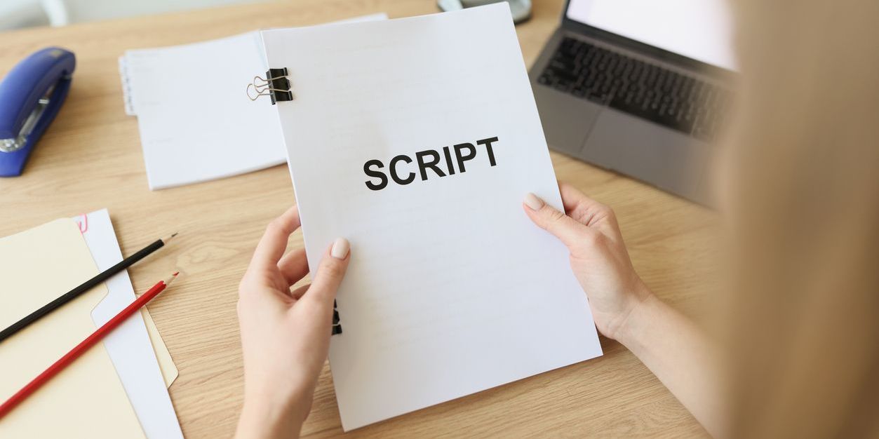 A script coordinator holding a script.