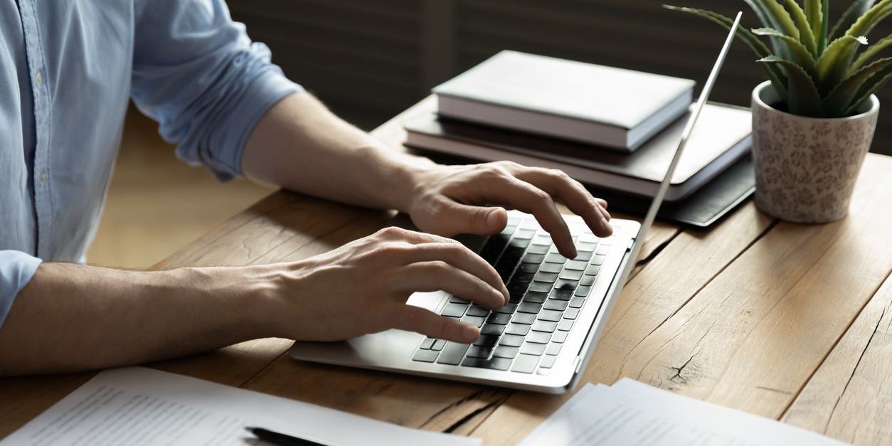 A showrunner typing on his computer.