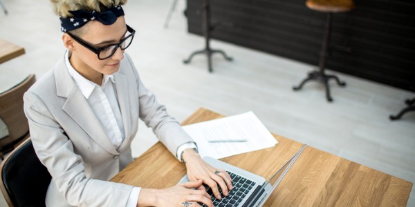 A young woman creating content for her blog on the computer.